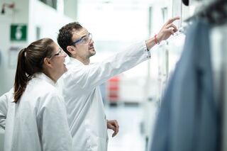 two scientists collaborating on a whiteboard