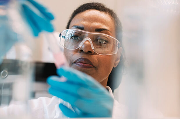 virologist wearing eyeglasses experimenting in laboratory