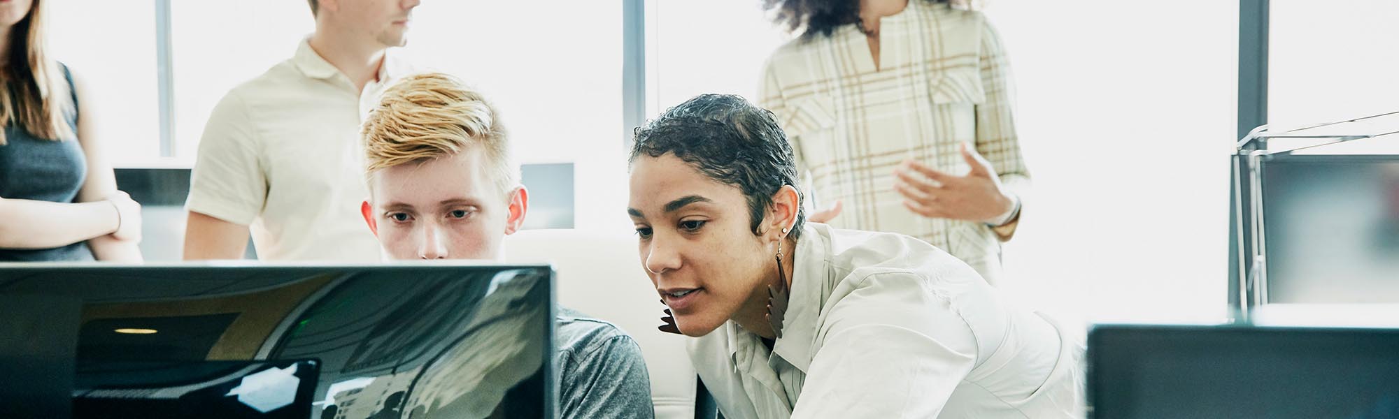 Two colleagues looking at a computer