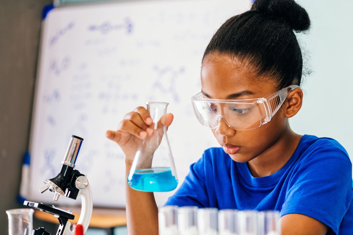 AstraZeneca woman scientist working in STEM-focused laboratory with pipette