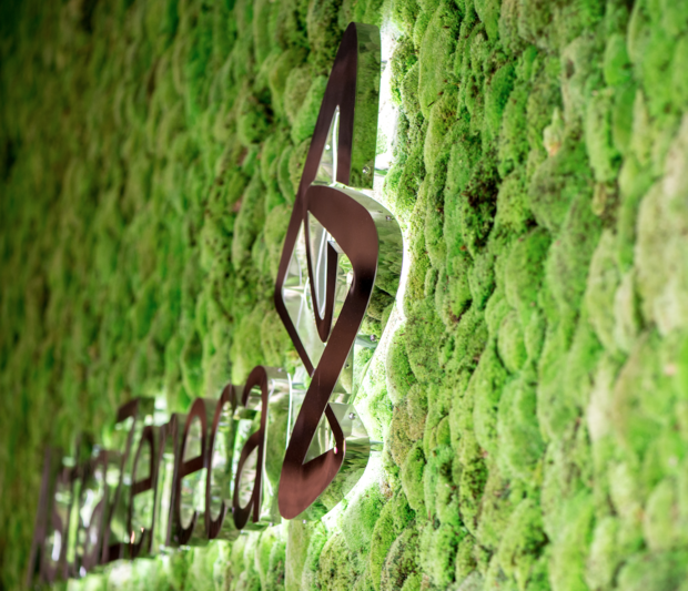 AstraZeneca logo on a living wall designed like a forest