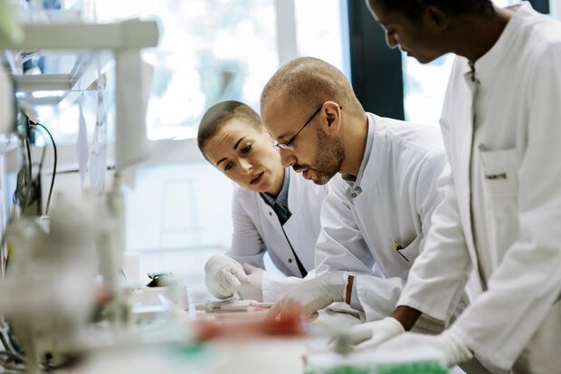 Two scientists sitting together focusing in a lab