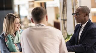 Three people in a meeting 