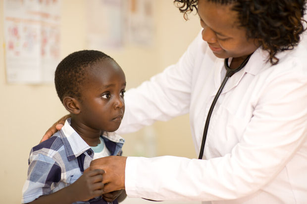 Doctor examining a child patient in a clinic