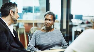 Image of two people interacting in an office environment